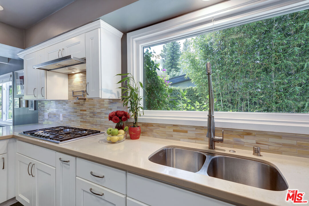16012 Meadowcrest Road Sherman Oaks, CA 91403 - Photo 17 of 52 a kitchen with sink a stove and cabinets