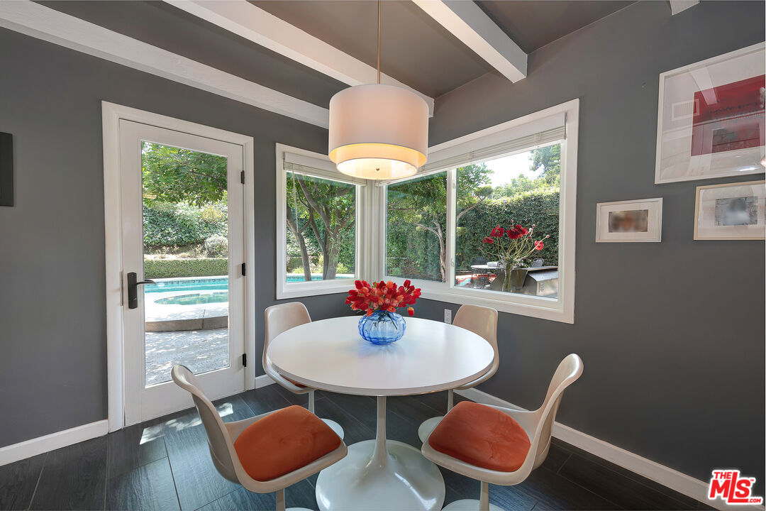 16012 Meadowcrest Road Sherman Oaks, CA 91403 - Photo 18 of 52 a kitchen that has table and chairs in it