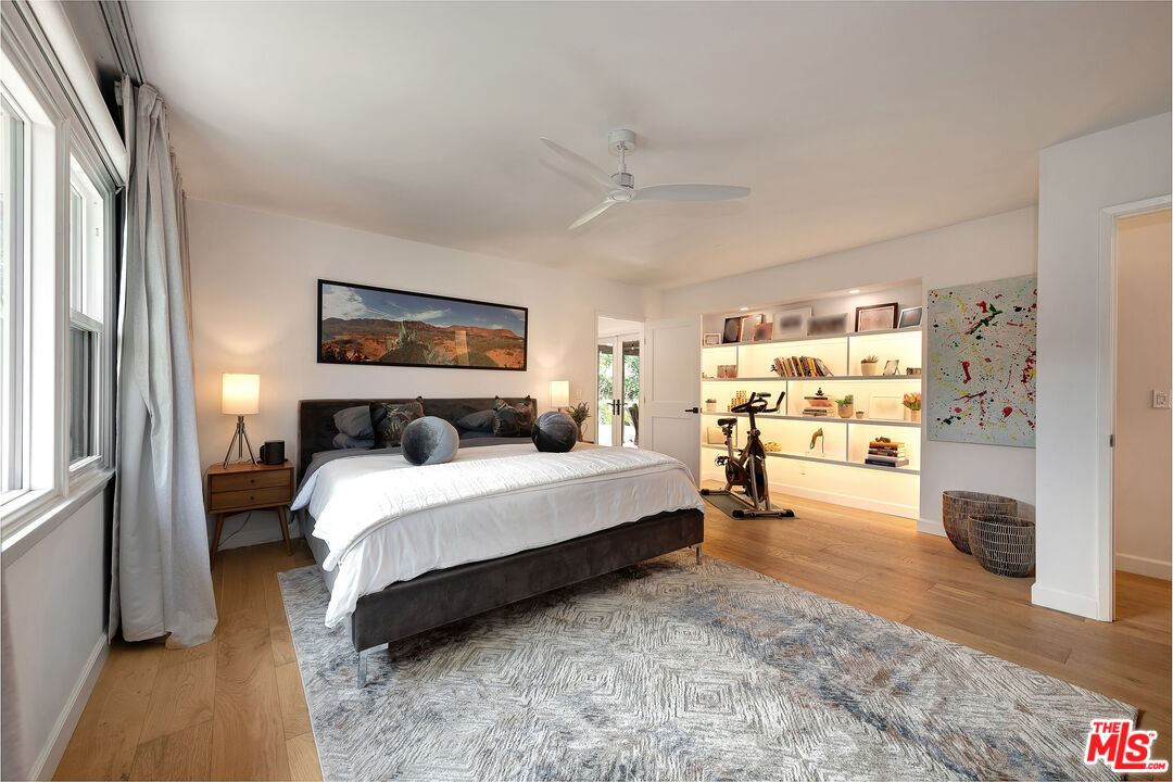 16012 Meadowcrest Road Sherman Oaks, CA 91403 - Photo 23 of 52 a spacious bedroom with a bed and a walk in closet