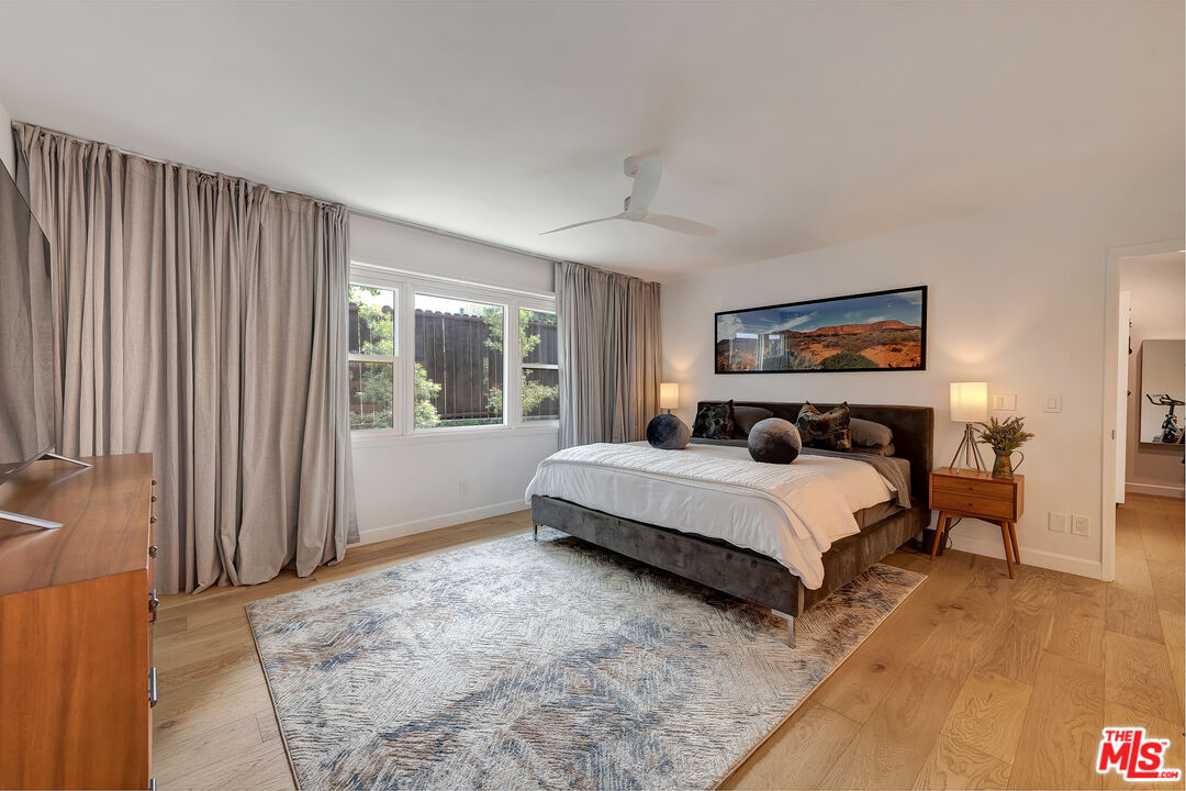 16012 Meadowcrest Road Sherman Oaks, CA 91403 - Photo 24 of 52 a bedroom with a large bed and a window