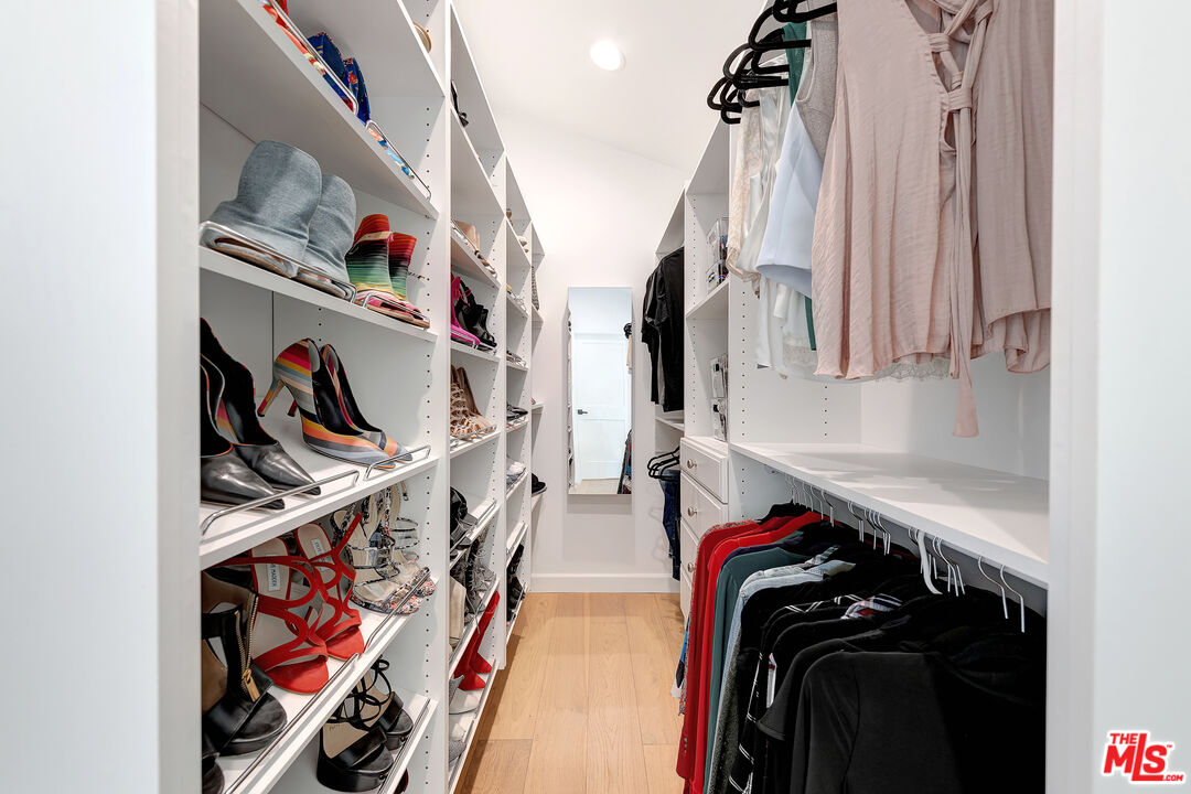 16012 Meadowcrest Road Sherman Oaks, CA 91403 - Photo 27 of 52 a view of walk in closet with clothes and shoes