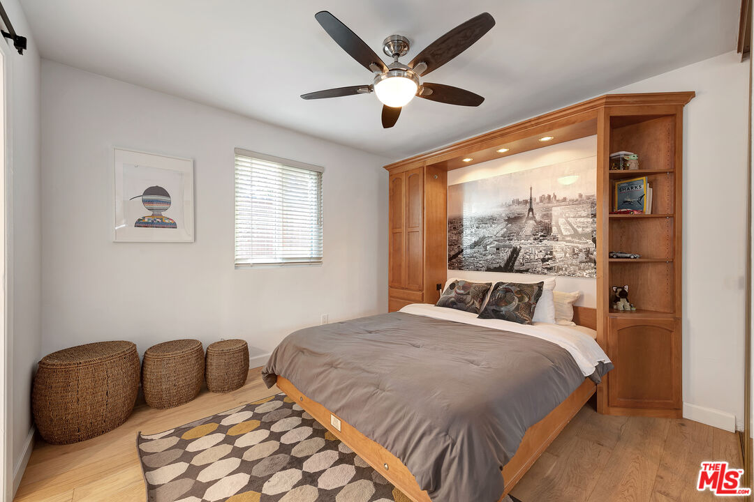 16012 Meadowcrest Road Sherman Oaks, CA 91403 - Photo 32 of 52 a bedroom with a bed and window