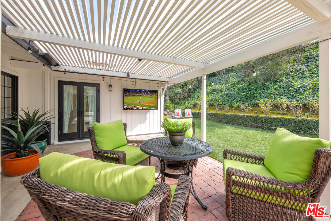 16012 Meadowcrest Road Sherman Oaks, CA 91403 - Photo 37 of 52 a view of a patio with couches chairs and a potted plant
