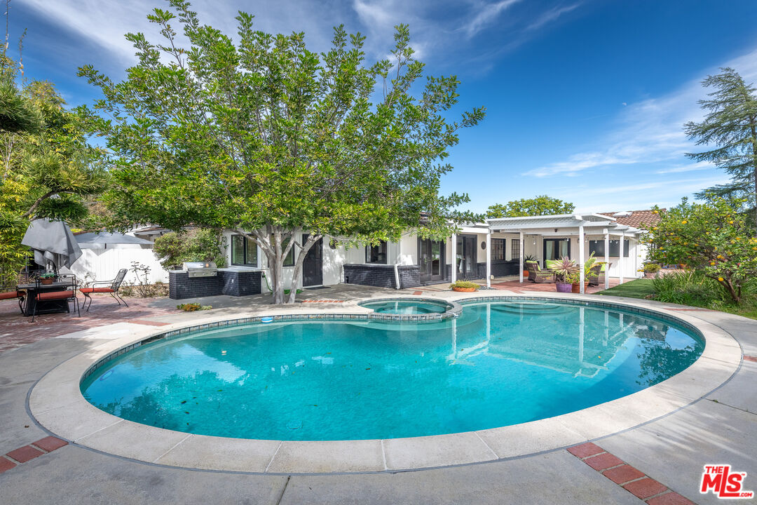 16012 Meadowcrest Road Sherman Oaks, CA 91403 - Photo 38 of 52 a view of a swimming pool with sitting area