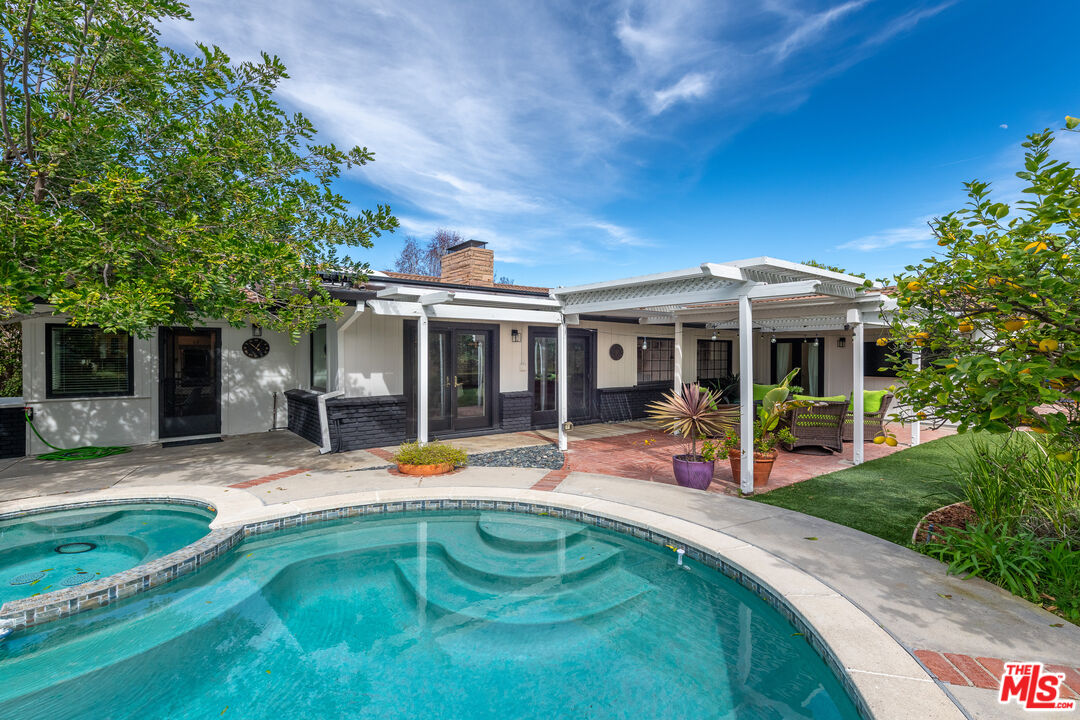 16012 Meadowcrest Road Sherman Oaks, CA 91403 - Photo 40 of 52 a view of a house with pool and sitting area
