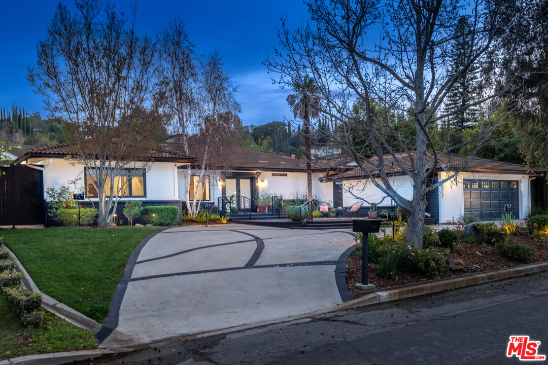 16012 Meadowcrest Road Sherman Oaks, CA 91403 - Photo 4 of 52 a front view of house with yard and green space