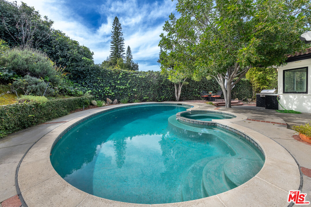 16012 Meadowcrest Road Sherman Oaks, CA 91403 - Photo 41 of 52 a view of a swimming pool with a outdoor seating