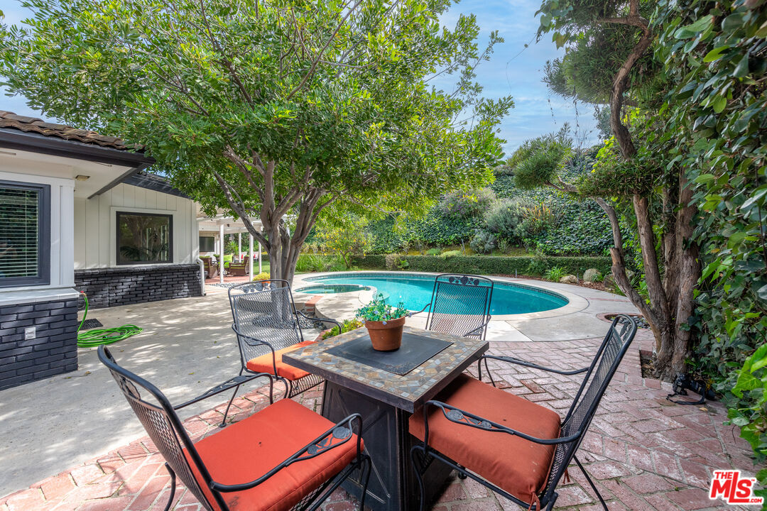 16012 Meadowcrest Road Sherman Oaks, CA 91403 - Photo 42 of 52 a view of a backyard with sitting area