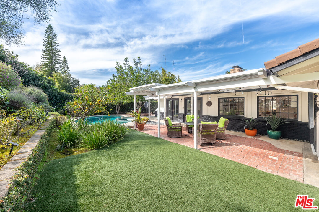 16012 Meadowcrest Road Sherman Oaks, CA 91403 - Photo 45 of 52 a view of a house with backyard sitting area and garden