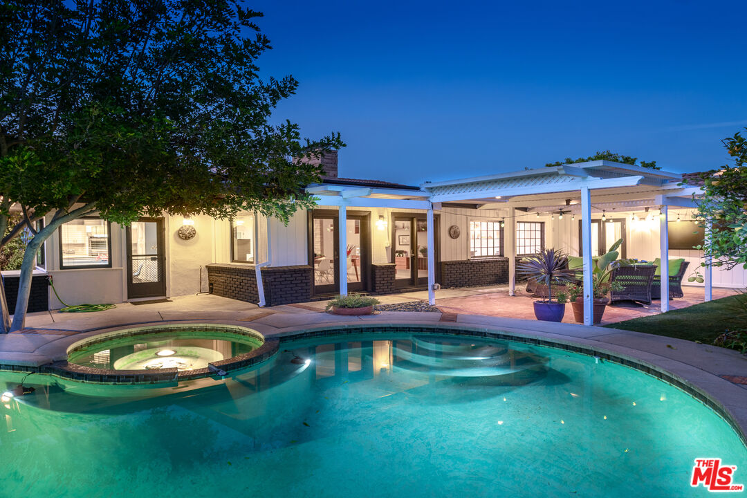 16012 Meadowcrest Road Sherman Oaks, CA 91403 - Photo 46 of 52 swimming pool view with a seating space and garden view