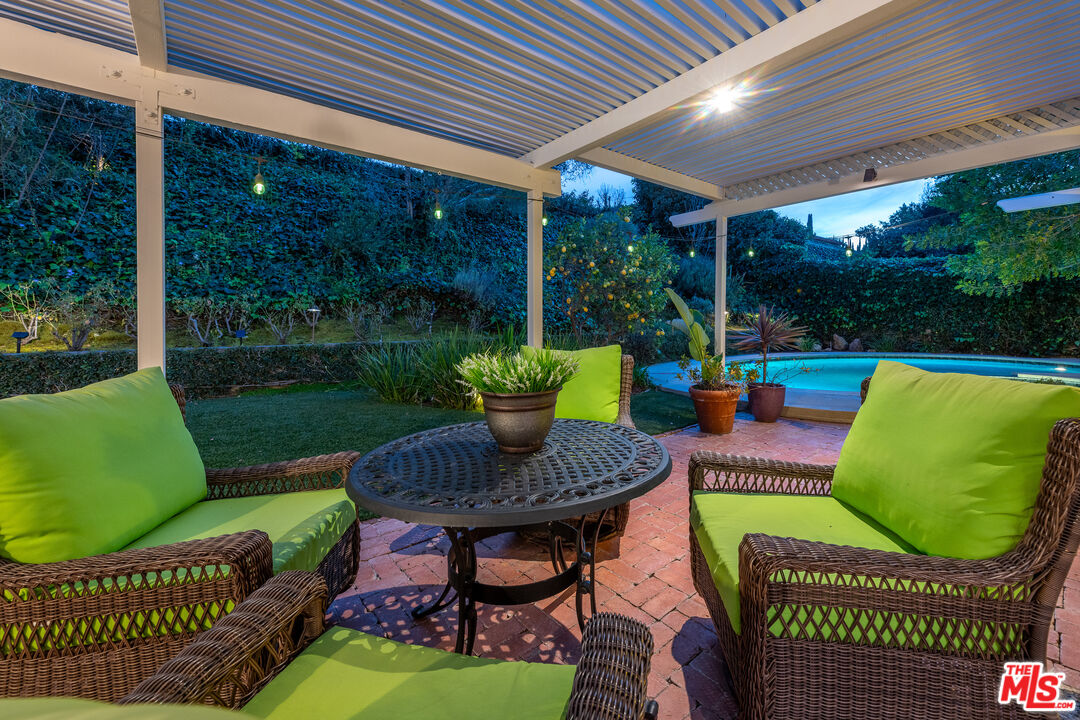16012 Meadowcrest Road Sherman Oaks, CA 91403 - Photo 48 of 52 a view of a porch with furniture and a yard