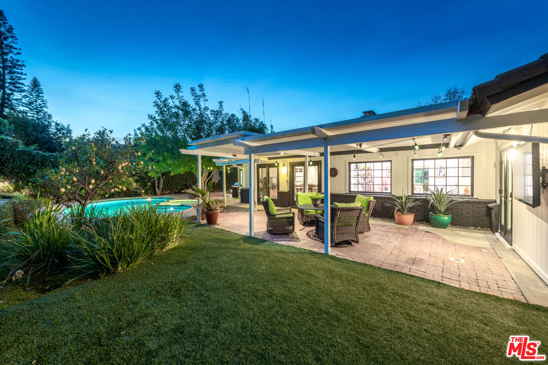 16012 Meadowcrest Road Sherman Oaks, CA 91403 - Photo 49 of 52 a view of a house with backyard porch and sitting area