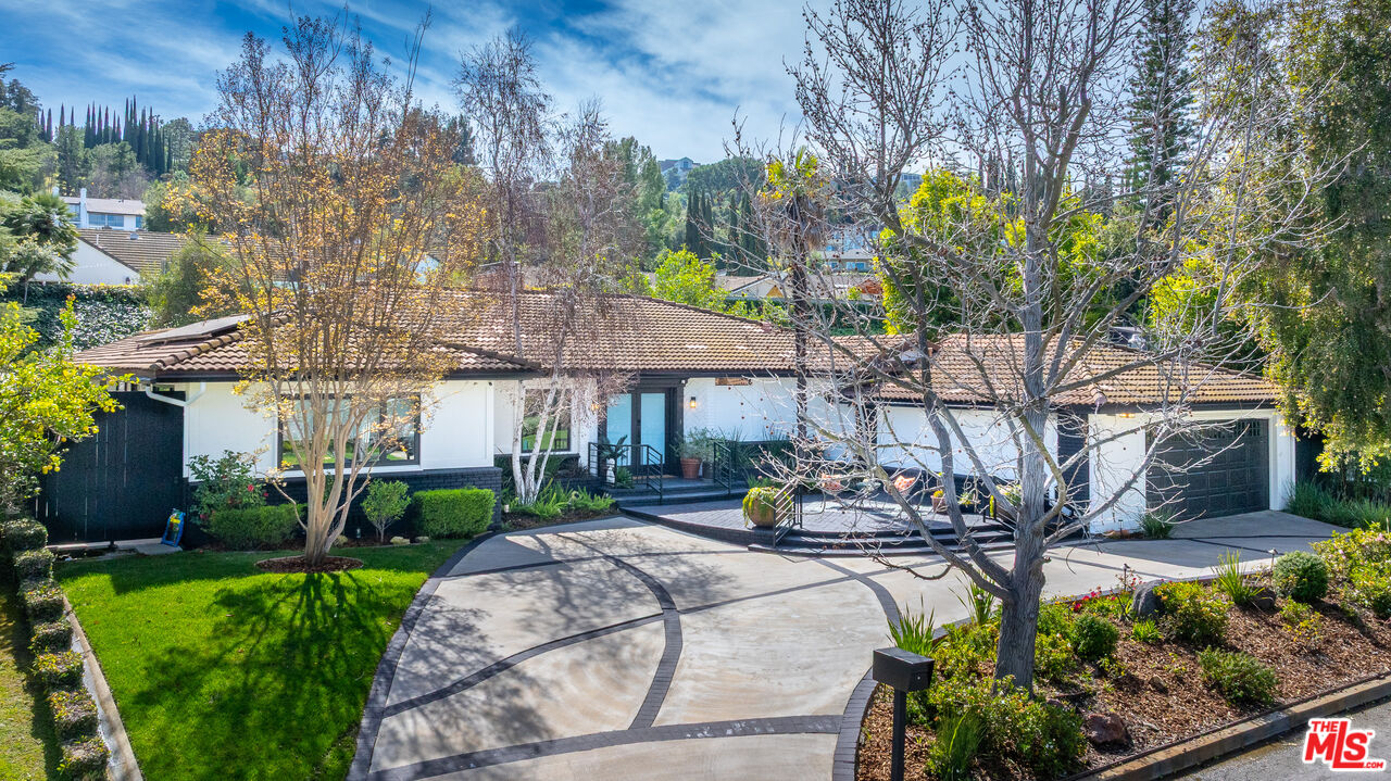16012 Meadowcrest Road Sherman Oaks, CA 91403 - Photo 6 of 52 a front view of a house with garden