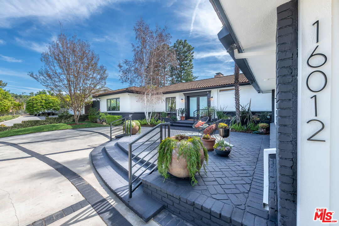 16012 Meadowcrest Road Sherman Oaks, CA 91403 - Photo 8 of 52 a view of a house with patio outdoor seating