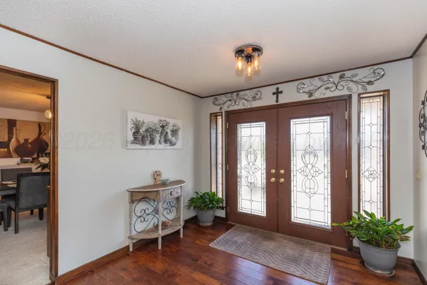 a kitchen with granite countertop a table chairs stove and cabinets