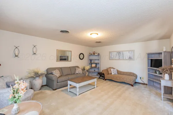 a kitchen with stainless steel appliances granite countertop a stove refrigerator and cabinets
