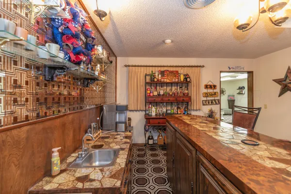 a view of a porch with dining table and chairs potted plants