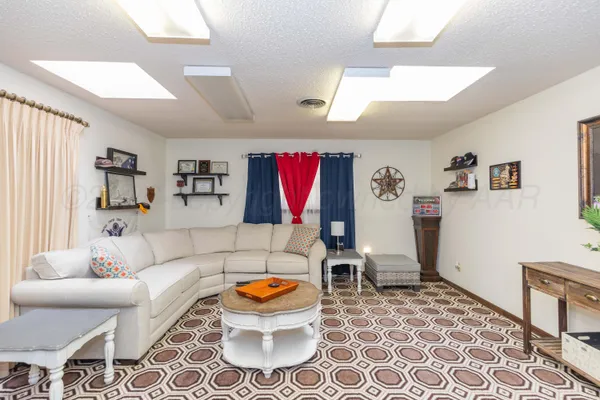 a living room with furniture fireplace and flat screen tv