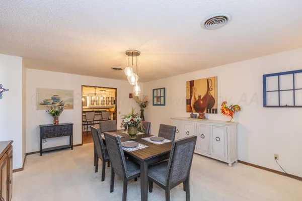 a living room with furniture kitchen view and a large window