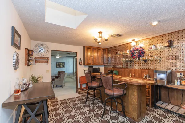 a living room with furniture a chandelier and a large window