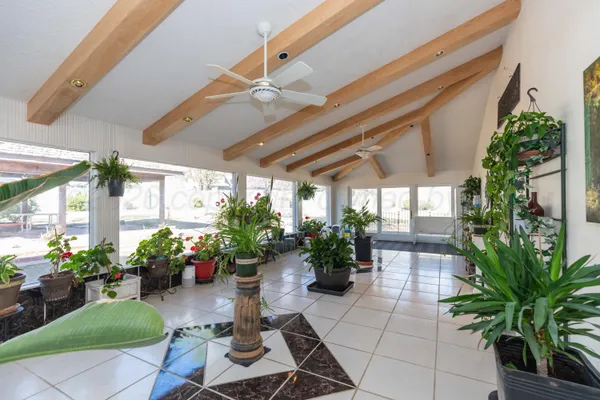 a spacious bedroom with a bed couch and window
