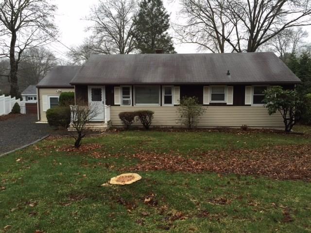 4 Flintlock Road Norwalk, CT 06850 - Photo 1 of 1 a backyard of a house with table and chairs under an umbrella