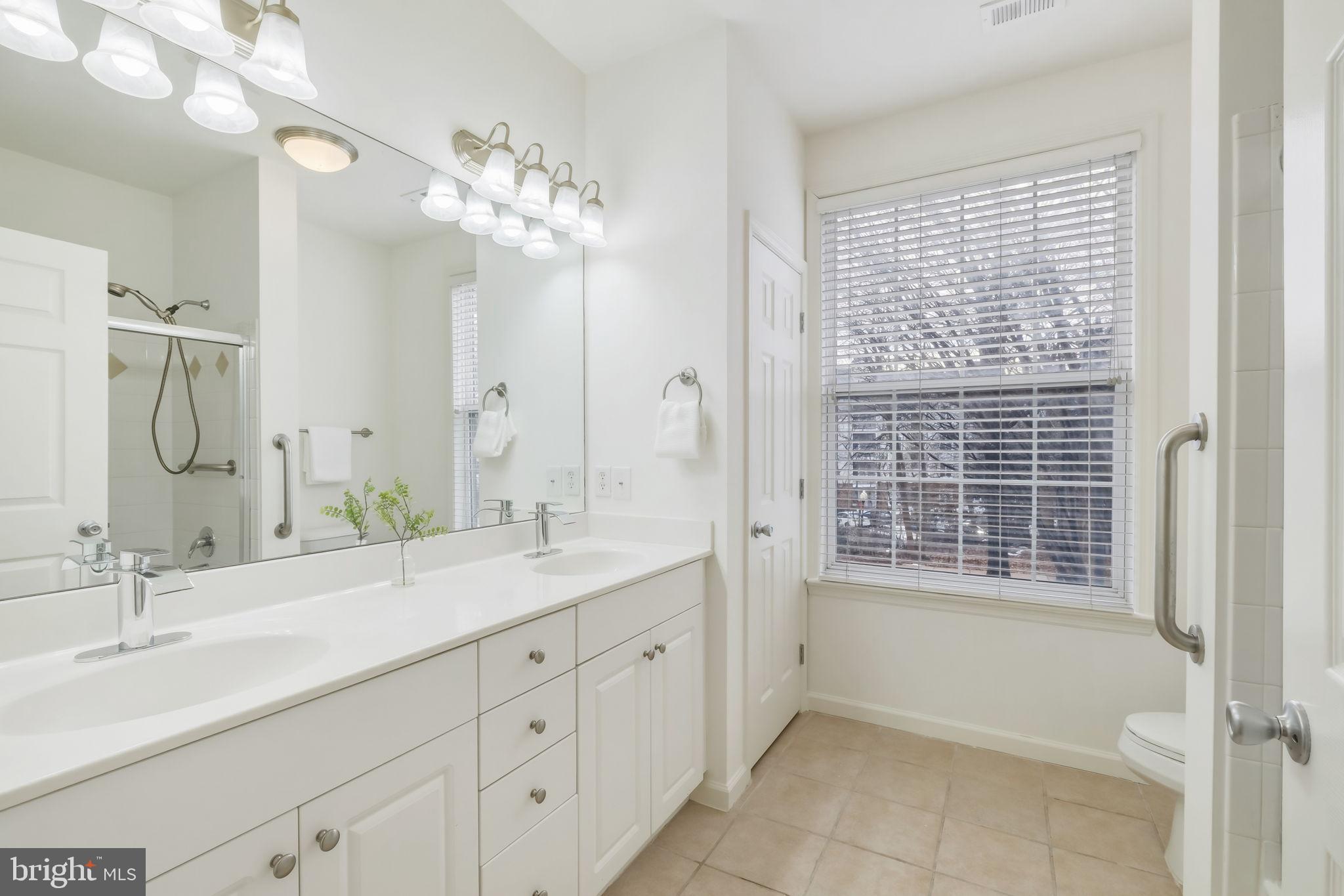 1 Arch Place, Unit 220 Gaithersburg, MD 20878 - Photo 14 of 26 Full Bathroom off hallway with double sink vanity