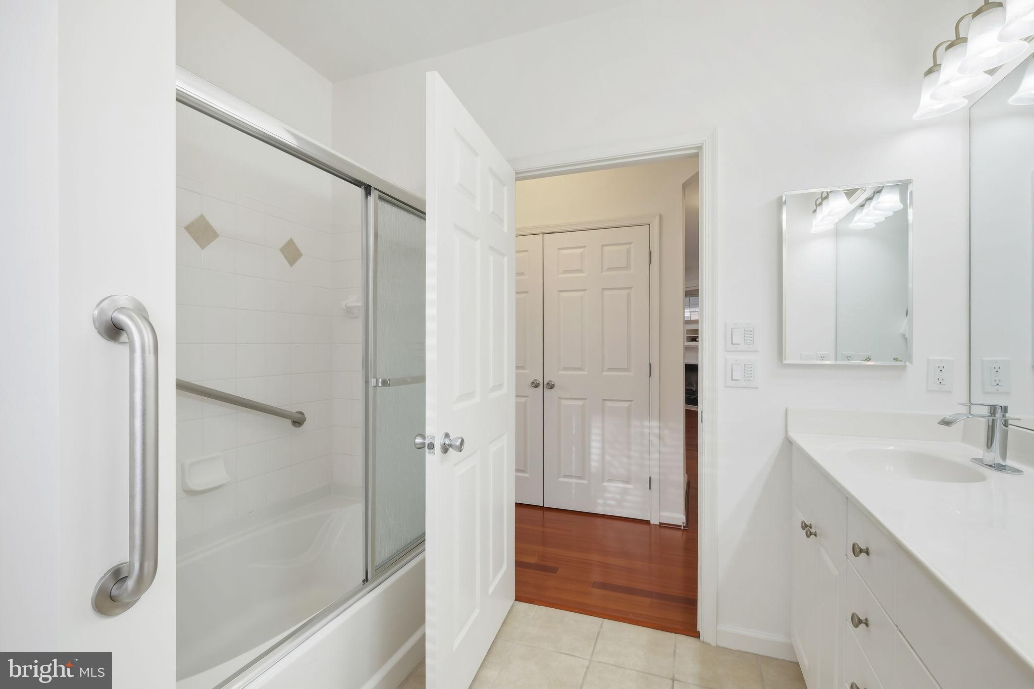 1 Arch Place, Unit 220 Gaithersburg, MD 20878 - Photo 15 of 26 Full Bathroom with shower/tub and glass doors