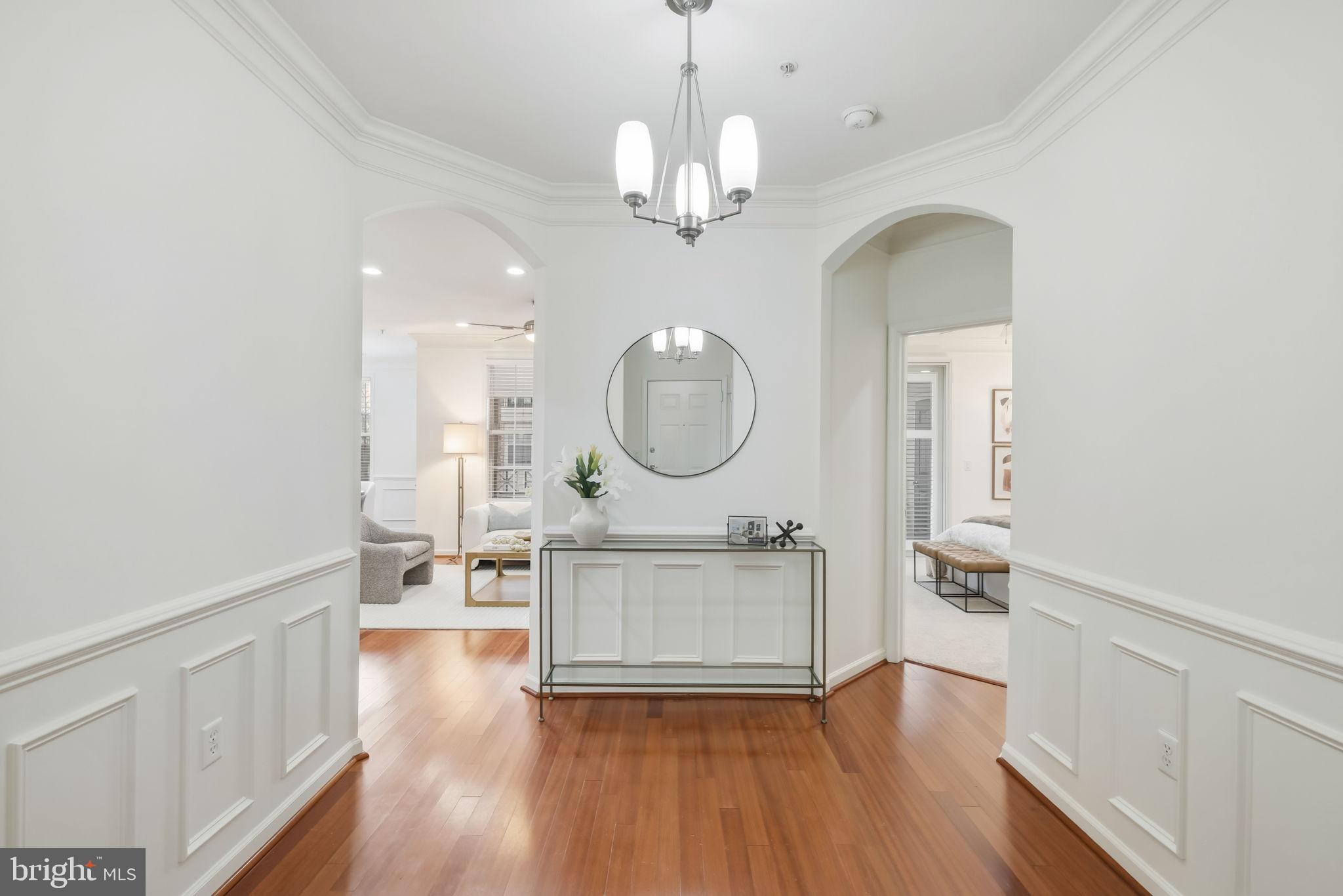1 Arch Place, Unit 220 Gaithersburg, MD 20878 - Photo 2 of 26 Grand Foyer with elegant moldings and guest closet