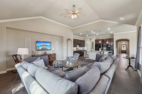 a living room with furniture and a chandelier