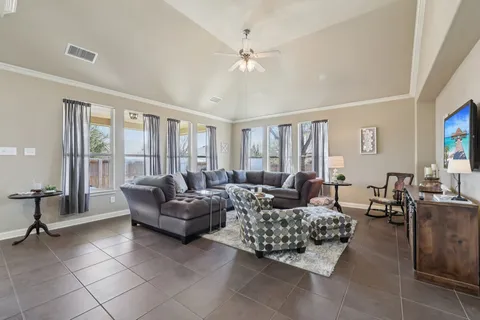 a living room with furniture and large windows