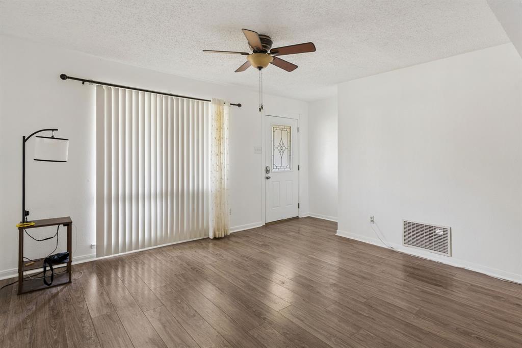 1822 Finley Road Irving, TX 75062 - Photo 8 of 38 wooden floor in an empty room with a window