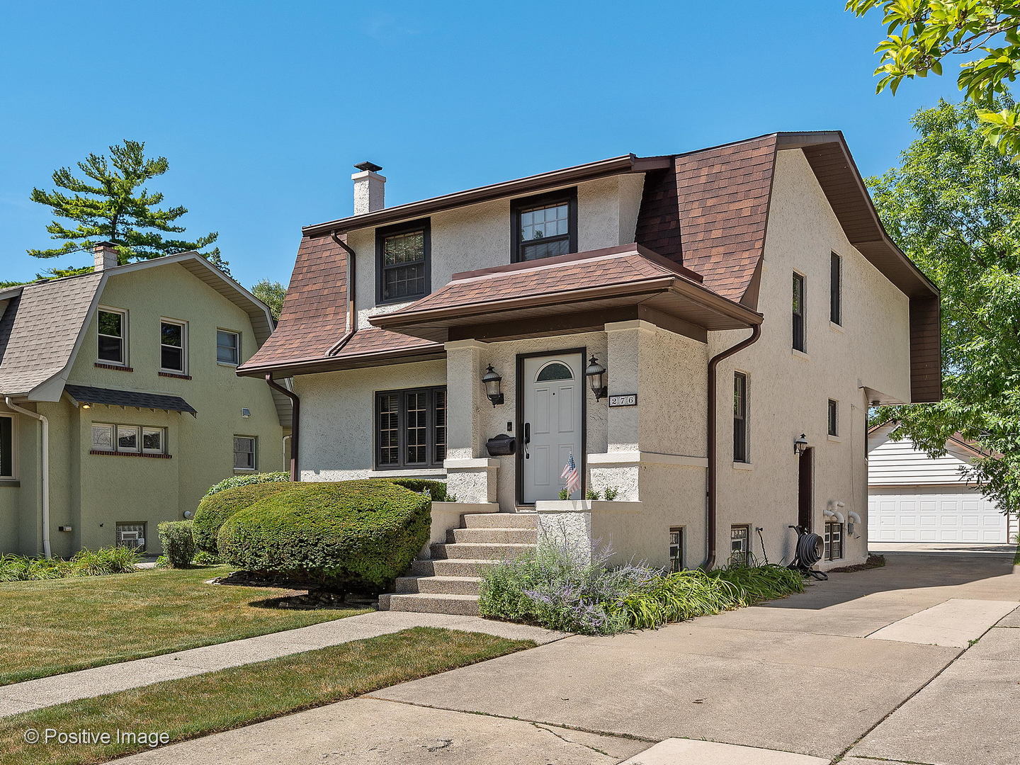 276 Blackhawk Road Riverside, IL 60546 - Photo 2 of 18 a front view of a house with garden