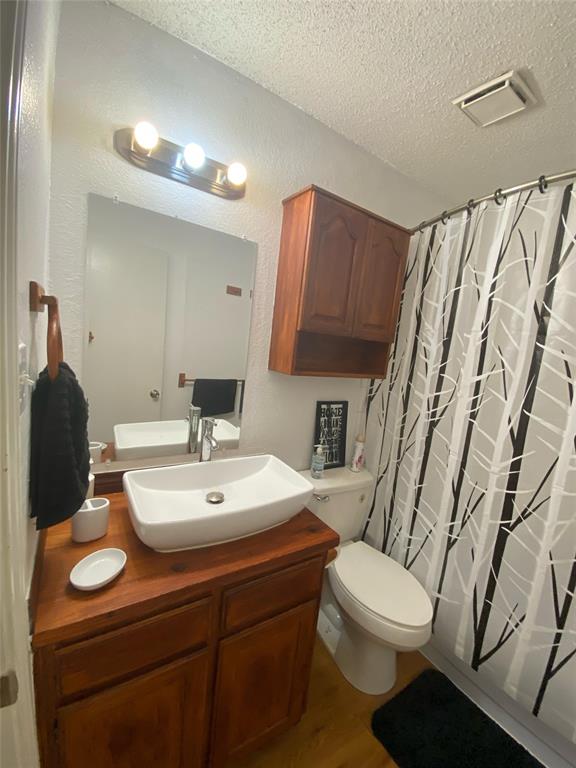 2022 Minnie Drive Arlington, TX 76012 - Photo 19 of 27 a bathroom with a toilet sink and mirror