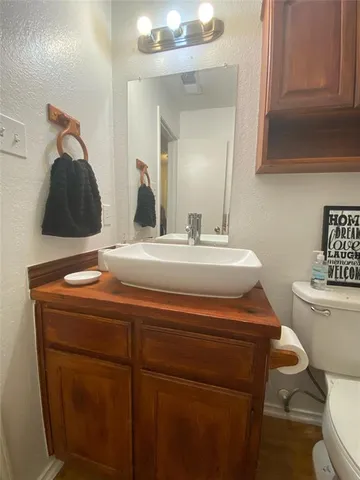 a bathroom with a sink a toilet a mirror and shower