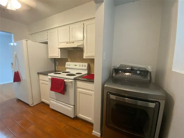 a kitchen with a stove and a refrigerator