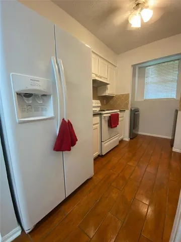 a kitchen with stainless steel appliances granite countertop a sink a stove top oven a counter space and cabinets