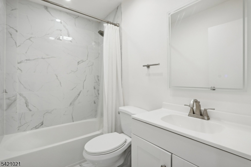 821 Hillside Road Rahway, NJ 07065 - Photo 13 of 33 a bathroom with a sink a toilet and shower