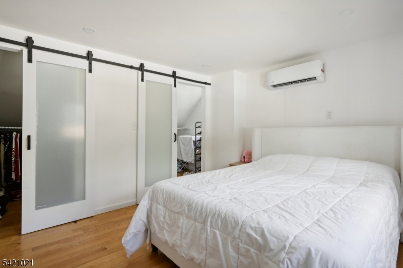 821 Hillside Road Rahway, NJ 07065 - Photo 14 of 33 a bedroom with a bed and a wooden floor