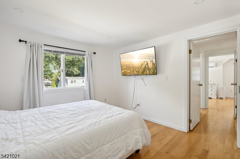 821 Hillside Road Rahway, NJ 07065 - Photo 16 of 33 a bedroom with a bed and a flat screen tv