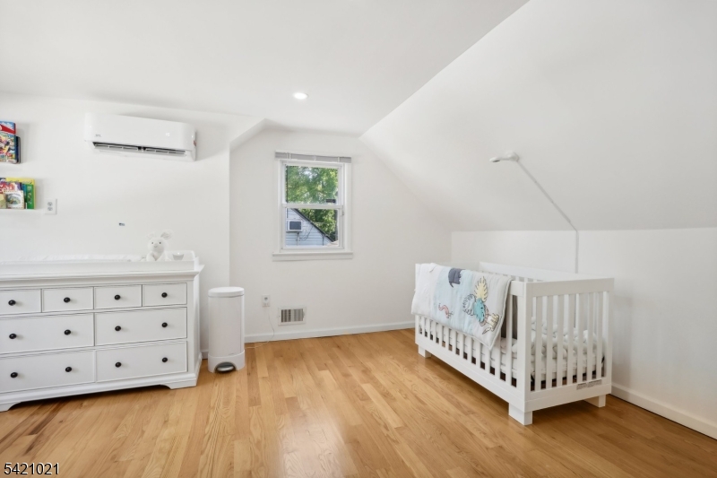 821 Hillside Road Rahway, NJ 07065 - Photo 21 of 33 a view of a bedroom with furniture and wooden floor