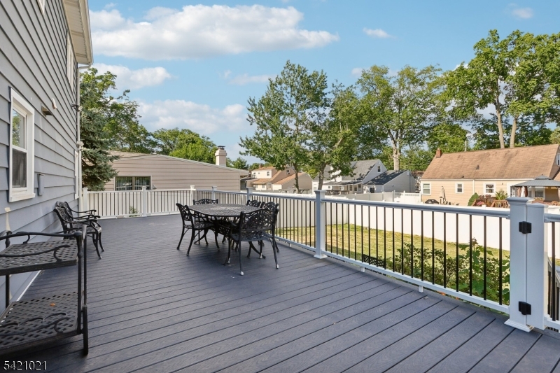 821 Hillside Road Rahway, NJ 07065 - Photo 28 of 33 a view of a roof deck with table and chairs and wooden floor