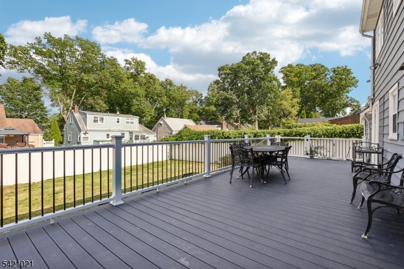 821 Hillside Road Rahway, NJ 07065 - Photo 30 of 33 a view of a roof deck with table and chairs and wooden floor
