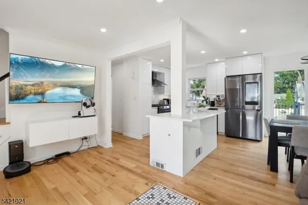 a kitchen with white cabinets and stainless steel appliances