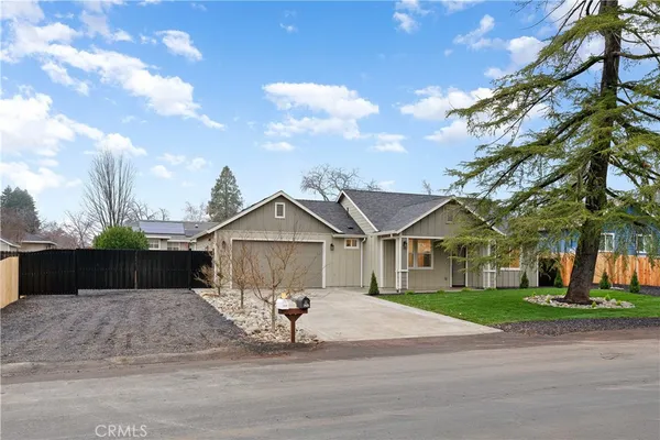 a view of a large house with a yard and large trees