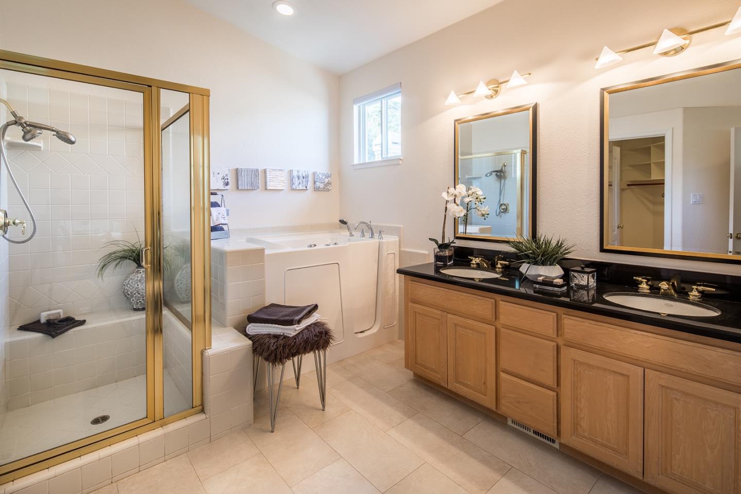 10439 Fairway Lane Carmel, CA 93923 - Photo 14 of 22 a bathroom with a double sink a toilet a mirror and shower
