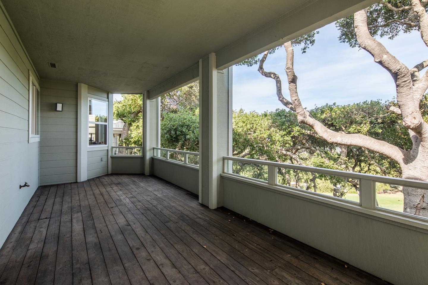 10439 Fairway Lane Carmel, CA 93923 - Photo 16 of 22 an empty room with wooden floor and windows