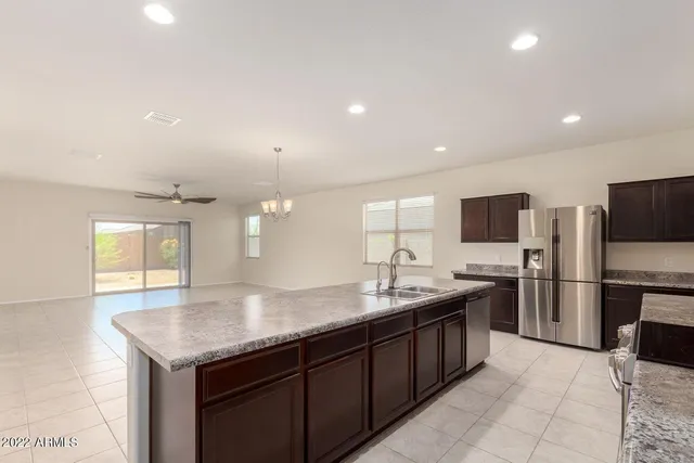 a kitchen with a sink a counter top space stainless steel appliances and cabinets