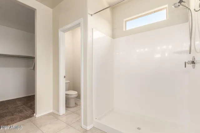 a bathroom with a granite countertop shower and a sink