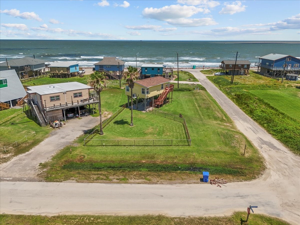 819 Seashell Drive Surfside Beach, TX 77541 - Photo 13 of 36 This coastal property features a raised home with a spacious fenced yard, offering direct views of the ocean. Situated in a serene neighborhood, it provides easy access to the beach and ample outdoor space for relaxation. Perfect for those seeking a beachside lifestyle.
